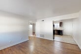 Located in Atlanta's 30318 corridor, this single-floor, 2-bedroom, 1-bathroom home offers a practical and clean layout designed for comfortable everyday living. Rich hardwood flooring flows throughout the main living areas and bedrooms, lending warmth and character to the neutral, white-walled interior.

The open living room provides a generous gathering space with natural light filtering in and direct sightlines to the kitchen, creating a connected feel. The kitchen features dark espresso cabinetry, light countertops, tile flooring, and a full suite of black appliances including a range, dishwasher, and refrigerator. A window above the sink brings in additional natural light.

Both bedrooms are well-proportioned with hardwood floors, large windows that invite outdoor views and daylight, and a clean, understated aesthetic. The primary bedroom offers a comfortable footprint with ample room for furnishings. Three closets distributed throughout the home provide strong storage capacity.

The bathroom includes a full tub-and-shower combination with white subway tile surround and a window for ventilation. A dedicated utility room with a visible electrical panel rounds out the home's functional spaces. A hallway connects the main areas efficiently, keeping the floor plan organized and easy to navigate.