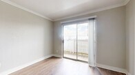 Located at 2700 Westridge St in Houston, TX, this one-bedroom, one-bathroom unit offers a practical and well-appointed layout across a single floor. Throughout the space, wood-look flooring and neutral-toned walls create a clean, cohesive aesthetic, while crown molding adds a refined architectural detail.

The combined kitchen and living area forms the heart of the unit. The living room features sliding glass doors that open to a private outdoor patio, filling the space with natural light. The kitchen is equipped with stainless steel appliances, including a full-size refrigerator and an electric range, complemented by light cabinetry, a range hood, and a granite-style countertop.

The bedroom is a comfortable, well-sized room featuring a ceiling fan with lighting, a window with exterior views, and wood-look flooring consistent with the rest of the unit. A dedicated closet provides additional storage.

The bathroom is a standout space, showcasing a decorative glass vessel sink set atop a granite-style vanity, a full soaking tub with a marble-patterned tile surround accented by a decorative border strip, and wood-look flooring that ties the room together cohesively.

Overall, this unit offers a functional and thoughtfully detailed living environment in a convenient Houston location.