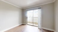 Located at 2700 Westridge St in Houston, TX, this one-bedroom, one-bathroom unit offers a practical and well-appointed layout across a single floor. Throughout the space, wood-look flooring and neutral-toned walls create a clean, cohesive aesthetic, while crown molding adds a refined architectural detail.

The combined kitchen and living area forms the heart of the unit. The living room features sliding glass doors that open to a private outdoor patio, filling the space with natural light. The kitchen is equipped with stainless steel appliances, including a full-size refrigerator and an electric range, complemented by light cabinetry, a range hood, and a granite-style countertop.

The bedroom is a comfortable, well-sized room featuring a ceiling fan with lighting, a window with exterior views, and wood-look flooring consistent with the rest of the unit. A dedicated closet provides additional storage.

The bathroom is a standout space, showcasing a decorative glass vessel sink set atop a granite-style vanity, a full soaking tub with a marble-patterned tile surround accented by a decorative border strip, and wood-look flooring that ties the room together cohesively.

Overall, this unit offers a functional and thoughtfully detailed living environment in a convenient Houston location.