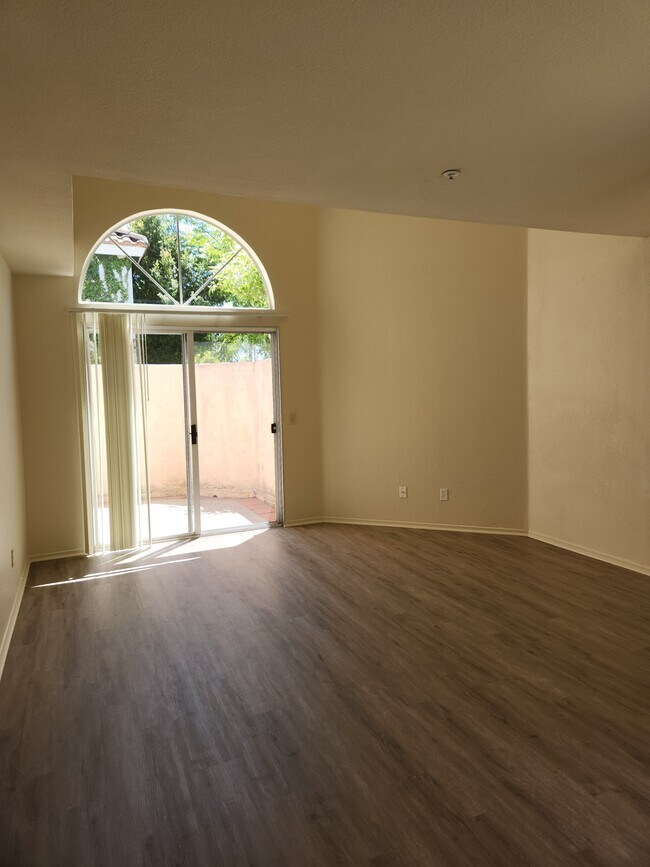 Living room with new LVP & attached patio - 9502 Walker St