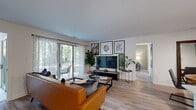 Located at 9807 Gable Ridge Terrace in Rockville, MD, this single-floor residence offers 2 bedrooms and 3 bathrooms within a thoughtfully designed layout. Light wood-style flooring flows throughout the main living areas, complementing the neutral color palette and creating a cohesive, modern aesthetic.

The living room serves as the heart of the home, featuring a sliding glass door that opens to a private balcony with tree-lined views, allowing ample natural light to fill the space. The adjacent dining area features a sage green accent wall, ceiling fan, and hardwood-toned flooring, adding warmth and character. The kitchen is equipped with white shaker-style cabinetry, light quartz countertops, and stainless steel appliances, including a gas range.

The primary bedroom offers multiple windows with outdoor views, plush carpet, and generous proportions. A walk-in closet with wire shelving provides practical storage. The second bedroom is similarly comfortable, with natural light filtering through blinds and curtains.

All three bathrooms feature clean white finishes, including white vanities and bright lighting. A dedicated utility room and additional closet round out the functional layout of this well-designed Rockville residence.