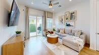 Located at 4180 Yardly Dr in Palmetto, FL, this single-story, one-bedroom, one-bathroom home offers a thoughtfully designed open-concept layout filled with natural light and modern finishes throughout. Light wood flooring flows seamlessly across the entire residence, creating a warm and cohesive aesthetic.

The kitchen and living area form the heart of the home, featuring crisp white shaker cabinetry extending to the ceiling, a white quartz island with seating, pendant lighting, and a full suite of stainless steel appliances including a refrigerator with ice maker, electric range, built-in microwave, and dishwasher. A classic white subway tile backsplash and a window above the sink add brightness and character to the kitchen. The adjacent living room is a comfortable, light-filled space with a large window and sliding glass door providing access to a private outdoor yard area.

The bedroom is a serene retreat with large windows framing views of lush greenery and palm trees, allowing ample natural light. It connects directly to a spacious walk-in closet with wire shelving and hanging rods offering generous storage. The bathroom features a glass-enclosed shower, light wood flooring, and a window for natural ventilation. The overall ambiance is clean, modern, and move-in ready.