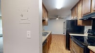Located at 13401 Morgan Ave S in Burnsville, MN, this one-bedroom, one-bathroom unit offers a well-organized single-floor layout totaling 670 square feet. The galley-style kitchen features rich wood cabinetry extending to the ceiling for ample storage, light stone countertops, a double-basin sink, and wood-look flooring — creating a practical and attractive cooking space. The kitchen opens through a hallway that connects seamlessly to the rest of the unit. The combined living area is generously sized, finished with neutral carpet, a textured ceiling, and a large window with vertical blinds that brings in natural light and outdoor views of the surrounding greenery. Baseboard heating runs along the perimeter of the living space. The bedroom is a well-proportioned retreat, also carpeted, and is equipped with a ceiling fan with light fixture, a window overlooking the outdoors, and a full-width mirrored sliding closet that adds both storage and a sense of openness. The bathroom is clean and functional, featuring a tiled tub-and-shower combination, a toilet, and classic white tile work. A hallway connects all areas of the unit efficiently. The overall aesthetic is neutral and move-in ready, with a calm, understated ambiance throughout.