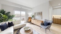 This well-appointed 2-bedroom, 1-bathroom unit at Starwood Drive in Guelph, Ontario offers a thoughtfully designed layout with modern finishes throughout. Light hardwood flooring flows seamlessly across the entire space, creating a warm and cohesive aesthetic.

The open-concept kitchen and living area serves as the heart of the unit. The kitchen is outfitted with two-tone cabinetry — white upper cabinets paired with warm wood lower cabinets — complemented by quartz countertops, under-cabinet lighting, and stainless steel appliances. A peninsula with bar seating provides additional prep space and casual dining. The adjoining living room is bright and inviting, featuring a sliding glass door that opens onto a private balcony with views of the surrounding landscape.

Both bedrooms are comfortably sized, with large windows that fill each room with natural light and offer pleasant outdoor views. The primary bedroom is particularly spacious, providing ample room for furnishings.

The bathroom is finished to a high standard, featuring white subway tile in the walk-in glass shower, a quartz vanity countertop, and clean white cabinetry. The unit also includes a dedicated laundry area and a closet for additional storage, rounding out a practical and stylish living space.