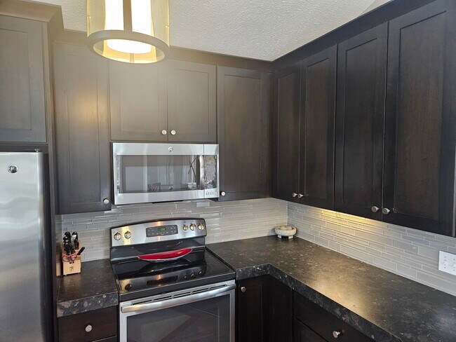 Stainless steel appliances grace this open concept kitchen designed for performance and style. - 7325 Golf Gate Dr
