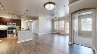 This single-story, 2-bedroom, 2-bathroom home offers a thoughtfully designed open-concept layout that seamlessly connects the living room and kitchen. The living area features rich hardwood-style flooring, crown molding, a ceiling fan, and multiple windows fitted with blinds that invite abundant natural light while offering outdoor views. A private entry door provides direct access to the living space.

The kitchen is a standout feature, showcasing dark espresso cabinetry, granite countertops, stainless steel appliances including a refrigerator, microwave, and dishwasher, along with a central island with seating and stylish pendant lighting overhead.

Both bedrooms are carpeted for comfort and include windows with blinds that bring in natural light. The primary bedroom is a well-sized retreat with its own dedicated closet access. Three closets total are distributed throughout the home, including a walk-in closet with wire shelving for organized storage.

The two bathrooms feature hardwood-style flooring, dark vanity cabinetry with granite countertops, and a tub-shower combination. A hallway connects the private areas of the home, completing a practical and cohesive floor plan that balances comfort and functionality throughout.