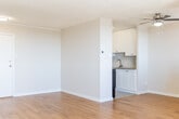 Located at 2199 Walker Ave in Peterborough, Ontario, this one-bedroom, one-bathroom unit offers a well-organized and efficiently designed layout across a single floor. Warm hardwood-style flooring flows throughout, complementing the clean, neutral palette of white walls and textured ceilings found in every room.

The living room is a bright and welcoming space, featuring a ceiling fan and large windows that frame sweeping elevated views of the surrounding Peterborough cityscape and rolling hills beyond. Baseboard heating runs along the perimeter, ensuring year-round comfort. The bedroom is a comfortable, well-proportioned room enhanced by a wide triple-pane window offering similarly impressive panoramic views. A full-width sliding-door closet provides generous built-in storage.

The galley-style kitchen is thoughtfully laid out with white cabinetry on both sides, light countertops, a stainless steel sink, and white appliances including a coil-top range and refrigerator. A flush-mount ceiling light keeps the space well-lit. The bathroom features a tiled shower-tub combination with chrome fixtures, maintaining the unit's clean and functional aesthetic.

Throughout the unit, the consistent flooring, bright natural light, and elevated views create a cohesive and comfortable living environment in the heart of Peterborough.
