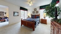 Located at 2562 Tenth St in Sarasota, Florida, this single-floor residence offers a thoughtfully arranged open-concept layout that connects the living, dining, and kitchen areas seamlessly. The living room is generously sized with plush carpeting, a sliding glass door that invites natural light, and direct access to an outdoor area. A large mirror accent wall in the dining area enhances the sense of openness, complementing the circular glass-top dining table and wicker seating beneath. The kitchen is efficiently designed with white cabinetry, light countertops, wood-look flooring, and a breakfast bar with bar stool seating — ideal for casual dining. The primary bedroom is spacious and bright, benefiting from multiple windows and a ceiling fan, with sliding glass door access to the outdoors. The second bedroom is cozy and well-lit, featuring a window with blinds and ample space for furnishings. Both bathrooms are finished with wood-look flooring, tub-shower combinations, vanity cabinetry, and clean neutral tones. Throughout the residence, a consistent palette of light walls and warm flooring materials creates a comfortable, welcoming ambiance well-suited to Florida living.