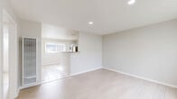 Located at 506-560 E 9th St in Azusa, CA, this single-story, one-bedroom, one-bathroom unit offers a clean and efficiently designed layout. The open living area features light wood-style flooring, recessed lighting, and soft neutral tones throughout, creating a bright and airy atmosphere. Large windows with vertical blinds allow natural light to fill the space, enhancing its welcoming feel.

The combined dining and kitchen area is well-appointed with white cabinetry, granite-style countertops, a stainless steel refrigerator, and a kitchen peninsula that serves as both a prep surface and casual dining counter. White tile flooring ties the kitchen and dining zone together seamlessly.

The bedroom is a comfortable, well-sized retreat featuring plush carpeting, a ceiling fan with light fixture, a sliding-door closet, and a window that brings in natural light. Two closets provide ample storage throughout the unit.

The bathroom is clean and functional, complete with a tiled shower/tub combo, a granite-topped vanity, and a small window for ventilation and light. A hallway connects the main living spaces, and a wall-unit air conditioner near the entry ensures climate comfort. The overall design is simple, functional, and move-in ready.