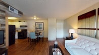 Located at 5400 N Nevada Ave in Colorado Springs, Colorado, this single-floor residence offers a thoughtfully designed layout that balances comfort and functionality. The open-concept living and dining area is anchored by rich hardwood-style flooring that flows seamlessly throughout the main living spaces, creating a warm and cohesive atmosphere. The living room features a striking reclaimed wood accent wall that adds rustic character, complemented by a sliding glass door that invites natural light and provides access to an outdoor area with exterior views.

The adjacent dining space comfortably accommodates a table for four and transitions naturally into the kitchen, which is equipped with white cabinetry, black appliances including an electric range and dishwasher, a double-basin sink, and ample counter space for meal preparation.

The residence includes two bedrooms, each finished with plush carpeting and ceiling fans. Natural light filters in through window treatments, creating a restful and private retreat. The bedrooms offer generous wall space suitable for personalized décor.

The full bathroom is cleanly appointed with a single-sink vanity, a toilet, and a shower-tub combination, offering a straightforward and functional design. A textured ceiling is consistent throughout the home, contributing to its classic residential character.