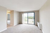 Located at 200 Ft Meade Rd in Laurel, Maryland, this 2-bedroom, 1-bathroom residence offers a practical and comfortable single-floor layout. The combined living and dining area is generously sized, featuring neutral-toned carpet, a textured ceiling, and a wall of natural light supplied by a sliding glass door that opens to a private balcony overlooking a lush, tree-lined landscape — a standout feature of the home.

The kitchen is efficiently designed with warm wood cabinetry, granite-look countertops, a gas range, stainless steel refrigerator, and a window that brings in additional natural light. Light hardwood-style flooring adds a clean, functional finish to this space.

Both bedrooms are carpeted and feature ample closet space — the second bedroom includes a double-door closet — and each room benefits from large windows with vertical blinds offering treetop views. Ceiling fans are present in the bedrooms, enhancing comfort year-round.

The bathroom is clean and bright, featuring light hardwood flooring, a full soaking tub with a tiled surround, and a dark-wood vanity with a white basin. A hallway with six closets provides exceptional storage throughout the home. The entrance leads to a well-connected layout that balances openness with defined room separation.