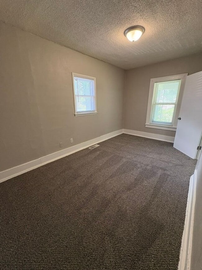 Building Photo - A cozy 2 bedroom home with versatile living space and plenty of storage including a partially fin...