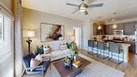 This single-story residence at 2389 Villa Dr in Cleveland, Tennessee offers a well-designed, open-concept layout that seamlessly connects the main living areas. The living room serves as a bright, welcoming centerpiece, featuring a ceiling fan, wood-look flooring, and French doors that flood the space with natural light while providing direct outdoor access.

The kitchen is outfitted with dark shaker-style cabinetry, granite countertops, a full suite of stainless steel appliances—including a refrigerator, range, microwave, and dishwasher—and pendant lighting over a breakfast bar, creating a functional yet stylish workspace. A dining area adjoins the kitchen, comfortably accommodating everyday meals.

The bedrooms offer carpeted floors and generous natural light from large windows. Each bedroom includes access to a walk-in closet with wire shelving systems for organized storage. The bathroom features a granite-topped vanity, tile flooring, and a shower-tub combination.

A dedicated in-unit laundry area houses a full-size washer and dryer with overhead shelving. Throughout the unit, neutral wall tones and consistent finishes contribute to a cohesive, modern aesthetic.
