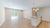 Located at 17151 Windward Blvd in Milford, Delaware, this single-floor residence offers a thoughtfully designed open-concept layout with modern finishes throughout. The heart of the home is a well-appointed kitchen featuring white shaker cabinetry, granite countertops, a classic subway tile backsplash, stainless steel appliances, and a central island with pendant lighting — all flowing seamlessly into the spacious living area. The living space is bright and airy, with light wood-style flooring, neutral walls, and a sliding glass door that fills the room with natural light and provides views of the surrounding greenery. Multiple bedrooms are carpeted for comfort, each equipped with a ceiling fan and windows fitted with blinds. The bedrooms connect to well-organized closet spaces and are positioned conveniently near the bathrooms. The bathrooms are clean and functional, featuring white vanities, wood-look flooring, and either a tub/shower combination or a walk-in shower. The consistent use of neutral tones, white trim, and light flooring throughout gives the entire residence a cohesive, fresh, and move-in ready ambiance.