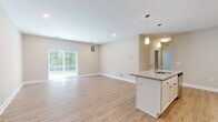 Located at 17151 Windward Blvd in Milford, Delaware, this single-floor residence offers a thoughtfully designed open-concept layout with modern finishes throughout. The heart of the home is a well-appointed kitchen featuring white shaker cabinetry, granite countertops, a classic subway tile backsplash, stainless steel appliances, and a central island with pendant lighting — all flowing seamlessly into the spacious living area. The living space is bright and airy, with light wood-style flooring, neutral walls, and a sliding glass door that fills the room with natural light and provides views of the surrounding greenery. Multiple bedrooms are carpeted for comfort, each equipped with a ceiling fan and windows fitted with blinds. The bedrooms connect to well-organized closet spaces and are positioned conveniently near the bathrooms. The bathrooms are clean and functional, featuring white vanities, wood-look flooring, and either a tub/shower combination or a walk-in shower. The consistent use of neutral tones, white trim, and light flooring throughout gives the entire residence a cohesive, fresh, and move-in ready ambiance.