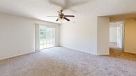 This single-story residence in Lafayette, Indiana offers a practical and well-organized layout across two bedrooms and two full bathrooms. The living area is carpeted and features a ceiling fan with light fixture, along with a sliding glass door that allows natural light to pour in and provides outdoor views — a standout feature of the main living space.

The kitchen is equipped with warm wood cabinetry, laminate countertops, and a full suite of white appliances including a refrigerator, electric range, microwave, and dishwasher. Light wood-style flooring runs throughout the kitchen, which connects conveniently to the main living area via a breakfast bar counter.

Both bedrooms are carpeted and include ceiling fans, windows that bring in natural light, and a bright, neutral color palette. The generously sized primary bedroom offers ample space, while a closet with bifold doors provides organized storage. Each bathroom features a tub/shower combination, a wood-vanity with laminate countertop, and wood-style flooring. The space also includes a dedicated utility room and an additional closet, adding to overall storage capacity.