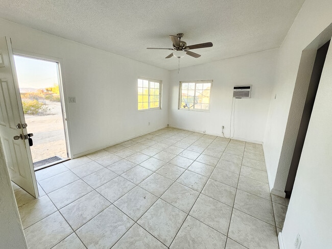 Living room with ceiling fan and natural light - 5527 Baileya Ave