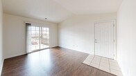 Located at 102 Camden Wood Place in Crestwood, Kentucky, this single-story, 2-bedroom, 2-bathroom home offers a well-organized layout designed for comfortable everyday living. The living room is a standout space, featuring vaulted ceilings that enhance the sense of openness, rich hardwood-style flooring, and a sliding glass door that floods the room with natural light and provides direct access to a private balcony. The entry foyer transitions seamlessly from tile to hardwood-style flooring, connecting the front door to the main living area. The kitchen is equipped with warm wood cabinetry, dark countertops, black appliances including a refrigerator and range, a dishwasher, and a sink — all set on light tile flooring with recessed lighting overhead. Both bedrooms continue the hardwood-style flooring and are well-proportioned, with the primary bedroom offering generous space. The two bathrooms feature tile flooring, warm wood vanities, and clean white fixtures; one includes a full tub-shower combination. Additional highlights include four closets for ample storage and a dedicated laundry area, making this a highly functional and practical home.