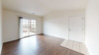 Located at 102 Camden Wood Place in Crestwood, Kentucky, this single-story, 2-bedroom, 2-bathroom home offers a well-organized layout designed for comfortable everyday living. The living room is a standout space, featuring vaulted ceilings that enhance the sense of openness, rich hardwood-style flooring, and a sliding glass door that floods the room with natural light and provides direct access to a private balcony. The entry foyer transitions seamlessly from tile to hardwood-style flooring, connecting the front door to the main living area. The kitchen is equipped with warm wood cabinetry, dark countertops, black appliances including a refrigerator and range, a dishwasher, and a sink — all set on light tile flooring with recessed lighting overhead. Both bedrooms continue the hardwood-style flooring and are well-proportioned, with the primary bedroom offering generous space. The two bathrooms feature tile flooring, warm wood vanities, and clean white fixtures; one includes a full tub-shower combination. Additional highlights include four closets for ample storage and a dedicated laundry area, making this a highly functional and practical home.