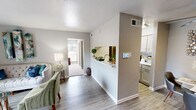 Located at 1620 Bay Area Boulevard in Houston, TX, this one-bedroom, one-bathroom unit is thoughtfully designed to maximize its compact footprint across a single floor. The open-concept living area features wood-look flooring and neutral gray tones, creating a bright and cohesive atmosphere. The living room flows seamlessly into the dining area, offering a comfortable and functional space for everyday living, complete with a ceiling fan overhead.

The galley-style kitchen is well-appointed with stainless steel appliances, light quartz countertops, and ample cabinetry finished in a soft gray tone. A pass-through window connects the kitchen to the living and dining areas, enhancing the sense of openness. A dedicated pantry provides additional storage convenience.

The carpeted bedroom is generously sized, offering two closets for storage. Natural light filters in through a window, adding warmth to the space. The full bathroom features a tub-shower combination with clean white tile finishes.

A private patio enclosed by a wood horizontal-slat fence extends the living space outdoors, offering views of the landscaped community grounds. The unit also benefits from a textured ceiling throughout and smart home controls, adding a modern touch to this practical and well-organized residence.