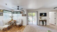 Located at 5601 Natomas Blvd in Sacramento, CA, this 2-bedroom, 2-bathroom single-story unit offers a well-organized floor plan designed to maximize functionality. The living room features plush carpeting, a ceiling fan, and a sliding glass door that opens to a private patio, allowing natural light to fill the space and providing a seamless indoor-outdoor connection. Adjacent to the living area, the dining space flows naturally from both the living room and kitchen, creating an open, connected layout ideal for everyday living.

The kitchen is equipped with light wood cabinetry, granite-style countertops, black appliances including a range, microwave, dishwasher, and refrigerator, and a charming arched window above the sink that adds architectural interest. Wood-style flooring runs throughout the kitchen and dining area, complementing the warm, neutral tones of the space.

Both bedrooms offer carpeted floors and ceiling fans, with the primary bedroom featuring a closet and a window with natural light. The two bathrooms include single-sink vanities with matching cabinetry and countertops, with one bathroom featuring a tub-shower combination and wood-style flooring. An in-unit laundry area and hallway storage round out the practical amenities of this well-appointed Sacramento residence.