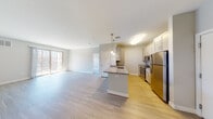 Located in Salem, MA, this thoughtfully designed one-bedroom, one-bathroom residence offers a functional and stylish single-floor layout. The open-concept kitchen flows seamlessly into the living area, centered around a granite-topped peninsula with bar seating — ideal for casual dining or entertaining. The kitchen is fully equipped with stainless steel appliances, including a refrigerator, range, microwave, and dishwasher, complemented by gray shaker-style cabinetry and light wood-look flooring. A dedicated dining nook adjacent to the kitchen provides an additional space for meals. The living room is generously proportioned, featuring sliding glass doors that flood the space with natural light and open to a private outdoor area. The bedroom offers plush carpeting, a large window with ample natural light, and room for a desk or workspace. The bathroom features a granite-topped vanity with gray cabinetry, a large mirror, and tile flooring, maintaining the consistent, modern aesthetic found throughout the home. Neutral tones and contemporary finishes create a cohesive, welcoming atmosphere throughout this well-designed residence.