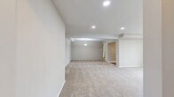 Located at 736 Camberley Cir in Towson, MD, this 2-bedroom, 1-bathroom residence offers a thoughtfully arranged single-floor layout with a clean, neutral aesthetic throughout. The open-concept living and dining area is a standout feature, providing generous room to relax and entertain. Plush wall-to-wall carpeting, recessed lighting, and a central pendant light fixture create a warm, inviting ambiance in this expansive shared space.

The kitchen is well-equipped with rich cherry wood cabinetry, white subway tile backsplash, light countertops, hardwood-style flooring, and white appliances including a range, microwave, and dishwasher. A window above the sink allows for natural light. An adjacent utility area houses a stacked washer and dryer for added convenience.

The spacious primary bedroom offers an impressive three-closet wall, providing abundant built-in storage with shelving and hanging space. The second bedroom features its own closet and a wide window with views of surrounding greenery. Five closets are distributed throughout the home, ensuring ample storage at every turn.

The full bathroom is finished with hardwood-style flooring, a wood-toned vanity with a white countertop, a large mirror, and a tub/shower combination with a window for natural ventilation. The overall design is clean, functional, and move-in ready.