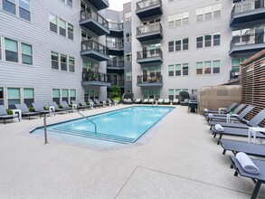 Relax by the sparkling courtyard pool—perfect for a refreshing dip or unwinding in a private lounge chair. - Modera Falls Church