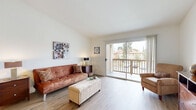 Located in Oceanside, California, this one-bedroom, one-bathroom residence offers a thoughtfully designed open-concept layout that makes efficient use of its single-floor footprint. Light wood-style flooring flows throughout the main living areas, complementing the bright, neutral color palette and vaulted ceilings that lend a sense of openness well beyond the physical footprint.

The living room is an inviting space anchored by a sliding glass door that opens to a private balcony, filling the room with natural light and providing pleasant outdoor views. The adjacent dining area transitions seamlessly into the kitchen, which features light wood cabinetry, a granite-toned countertop, a peninsula breakfast bar, and white appliances including a range, microwave, and refrigerator — all set beneath soaring ceilings that enhance the airy feel.

The bedroom is a comfortable retreat finished with plush carpet, a large window for natural light, and access to a spacious walk-in closet with dual hanging rods and shelving. A second closet provides additional storage. The full bathroom includes a wood-toned vanity with a granite-style countertop, a tub-shower combination, and wood-style tile flooring. This well-appointed residence offers a clean, functional living experience in a sunny Southern California setting.