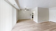 Located at 1414–1422 Som Center Rd in Mayfield Heights, Ohio, this one-bedroom, one-bathroom unit offers a well-organized single-floor layout designed for comfortable everyday living. The open-concept combined living and dining area is bright and inviting, featuring light-toned luxury vinyl plank flooring, a textured ceiling, and a ceiling fan with integrated lighting. A full-width sliding glass door floods the space with natural light and provides access to an outdoor area, complemented by vertical blinds for privacy. The kitchen is thoughtfully updated with crisp white shaker-style cabinetry, stone-look countertops, a stainless steel sink, and stainless steel appliances including a refrigerator, range, and dishwasher — all set over matching light wood-style flooring. The bedroom offers plush carpeting, a large window with vertical blinds, and generous closet space with bifold doors, making it a comfortable and functional retreat. The bathroom includes a full tub and shower combo with clean white tile surround and chrome fixtures. Throughout the unit, neutral warm-toned walls create a cohesive, move-in-ready aesthetic. With five closets distributed across the layout, storage is a notable strength of this well-appointed home.