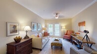 Located at 1101 Berkley Manor Way in Greensboro, NC, this single-floor residence offers a thoughtfully designed layout with quality finishes and a warm, inviting ambiance throughout. The living room is a welcoming focal point, featuring crown molding, plush carpeting, a ceiling fan, and French doors that invite natural light and provide outdoor access. The space comfortably accommodates seating and additional furnishings, making it ideal for both relaxing and entertaining. The kitchen is well-equipped with warm honey-toned cabinetry, granite countertops, stainless steel appliances, and rich hardwood-style flooring. A peninsula with bar seating adds a functional casual dining option and opens toward the entry area. The bedrooms are carpeted and finished with ceiling fans, neutral tones, and natural light from windows with blinds, creating a calm and restful atmosphere. The bathrooms feature hardwood-style flooring, full soaking tubs with shower combinations, and granite-topped vanities, offering a clean and comfortable design. Crown molding and consistent warm neutral tones carry throughout the home, lending a cohesive and polished aesthetic from room to room.