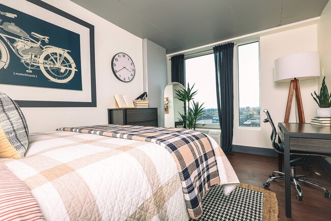 Experience urban living with elegance in this tastefully designed bedroom, perfect for relaxation and productivity. - Avery Philly