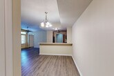 Located in Saint Charles, Missouri, this two-bedroom, one-bathroom courtyard unit offers a well-organized single-floor layout designed for comfortable everyday living. The open living and dining areas feature durable wood-style plank flooring, warm neutral-toned walls, and an abundance of natural light streaming through multiple windows with horizontal blinds. A ceiling fan in the main living area and a decorative chandelier in the dining space add functional character to the shared areas. The front entry features a glass-panel door with a transom window above, further enhancing natural light throughout.

The kitchen features warm-toned wood cabinetry, light countertops, a double stainless steel sink, and black appliances including a range, microwave, and refrigerator. A pass-through counter connects the kitchen to the living and dining areas, creating an open, communicative flow. Both bedrooms are carpeted and include closets with built-in shelving. The second bedroom offers a window with a view of the courtyard pool area. The full bathroom includes a clean white tub-shower combination with chrome fixtures. Adding everyday convenience, an in-unit laundry area accommodates a full-size washer and dryer side by side.
