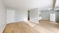 Located at 1321 Veterans Hwy in Bristol, PA, this single-floor, two-bedroom, one-bathroom unit offers a clean and functional layout designed for efficient everyday living. Light-toned hardwood flooring runs throughout the entire space, creating a cohesive and airy feel from room to room. The open living area is generously proportioned, bathed in natural light, and flows seamlessly into the kitchen, which features white cabinetry, a gas range, and a refrigerator—providing a practical and tidy cooking space. Both bedrooms are well-sized and feature large windows fitted with blinds that allow for adjustable natural light. The primary bedroom is notably spacious and includes a built-in closet with sliding doors, offering ample storage. The second bedroom similarly features a closet and a bright window. Neutral gray walls complement the light flooring throughout, contributing to a calm and modern aesthetic. The full bathroom is neatly appointed with a white tub-shower combination, a toilet, and a vanity with white cabinetry and a clean countertop. Chrome fixtures and consistent white finishes give the bathroom a tidy, updated appearance. Overall, the unit presents a well-maintained, move-in-ready living space with a simple, contemporary style.
