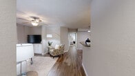 Located at 1767 Hermitage Blvd in Tallahassee, FL, this single-floor, 3-bedroom, 2-bathroom home offers a well-designed layout across a compact yet functional footprint. Wood-look flooring runs throughout the main living areas, complemented by neutral tones and textured ceilings that add character throughout.

The open living room is bright and airy, featuring a ceiling fan, built-in media cabinetry with white cabinet storage, and a sliding glass door that opens to a private outdoor patio. The adjacent dining area includes a tray ceiling detail and pendant lighting, creating a defined space for meals. The kitchen is outfitted with white cabinetry, a subway tile backsplash, stainless steel appliances, and a peninsula counter that provides additional prep and serving space.

The primary bedroom is a comfortable retreat with plush carpet, a ceiling fan, and ample natural light. The additional bedrooms also feature carpet, ceiling fans, and windows with natural light. Both bathrooms are finished with wide vanity countertops, white cabinetry, and full-width mirrors. A dedicated laundry area with an in-unit washer adds everyday convenience. A hallway and closet round out the well-organized floor plan.