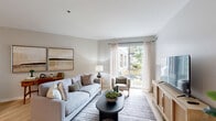 Located at 450 Warrenville Rd in Lisle, IL, this well-appointed one-bedroom, one-bathroom residence offers a thoughtfully designed single-floor layout. The open-concept living, dining, and kitchen area serves as the heart of the home, bathed in natural light from large sliding glass doors that frame outdoor views and create a bright, airy atmosphere. Light hardwood-style flooring flows throughout the main living areas, complementing the neutral color palette.

The kitchen is a standout feature, showcasing rich dark wood cabinetry, a herringbone tile backsplash, white quartz countertops, and a full suite of stainless steel appliances. A peninsula with pendant lighting and bar seating provides both additional prep space and a casual dining option.

The generously sized bedroom offers plush carpeting and a calm, neutral ambiance, supported by ample storage across four closets throughout the residence. The bathroom features dark wood cabinetry, a wide vanity with white countertop, a large mirror with contemporary lighting, and tile flooring.

Additional highlights include an in-unit laundry area, a dedicated workspace nook in the living area, and a clean, modern design aesthetic throughout that balances comfort and functionality.