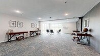 Located at 3425 Eischen Ct in Duluth, Minnesota, this well-appointed single-floor professional space offers a thoughtfully designed layout ideal for office or collaborative use. The interior is finished with neutral tones, patterned carpet tiles throughout, and recessed lighting that creates a clean, modern ambiance.

The main open area serves as a versatile lounge and workspace, featuring large windows that invite abundant natural light and views of the surrounding landscape. This central zone is furnished with individual desks along the walls, providing dedicated workstation areas, while a seating arrangement at the center accommodates group interaction or informal meetings.

A separate, enclosed conference room offers a more private setting, equipped with a substantial wooden table and ample seating for a full team. The room features clean white walls and recessed lighting, making it well-suited for focused meetings or presentations.

An additional workspace area, accented by a bold charcoal feature wall, houses individual desks and opens into the main lounge, offering flexible use as a private office or collaborative zone. Framed botanical artwork adds a refined decorative touch throughout.

The space also includes a fully ADA-accessible restroom, finished with classic white subway tile wainscoting, polished concrete-look flooring, stainless steel grab bars, and a wall-mounted vanity — combining practicality with a clean, contemporary aesthetic.