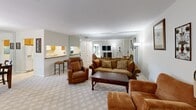 Located in Okeechobee, FL, this single-floor, 2-bedroom, 2-bathroom residence offers a practical and comfortable layout designed for everyday living. The combined living and dining area serves as the heart of the home, featuring light-toned carpeting, large mirrored wall panels that enhance the sense of space, and a pass-through opening to the kitchen that promotes an open, connected feel. The kitchen is equipped with warm wood cabinetry, a double sink, and full appliances including a refrigerator, range, and dishwasher, all set on easy-care tile flooring. The primary bedroom is a generously sized retreat with multiple windows dressed in blinds that allow for adjustable natural light, and is paired with a dedicated closet for ample storage. The second bedroom offers a bright, airy atmosphere with carpet flooring and convenient hallway access. Both bathrooms are functional, with one featuring a tub/shower combination and wood-toned cabinetry. A hallway connects the living spaces to the bedrooms, with additional closet space and a utility room providing practical storage. A balcony offers an outdoor retreat, while the overall neutral palette and carpeted common areas create a calm, cohesive ambiance throughout.