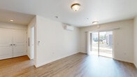 Located at 425 Bradley Blvd in Richland, WA, this well-appointed one-bedroom, one-bathroom unit offers a thoughtfully designed layout across a single floor. The open-concept living and kitchen area is bright and welcoming, finished with warm wood-look luxury vinyl plank flooring throughout. The kitchen is a standout feature, equipped with modern light wood cabinetry, white quartz countertops, a breakfast bar peninsula, and a full suite of stainless steel appliances including a refrigerator, electric range, and microwave. A pendant light over the peninsula adds a polished touch. The living area is generously proportioned, filled with natural light from a sliding glass door that opens to an outdoor patio and provides views of the surrounding landscape. A wall-mounted mini-split unit ensures efficient climate control. The bedroom is a comfortable retreat with plush carpeting, a sliding closet, and a window that offers neighborhood views. It also features its own mini-split unit for personalized comfort. The bathroom is clean and functional, finished with wood-look flooring, a light wood vanity, and modern chrome fixtures. Throughout the unit, crisp white walls and contemporary finishes create a clean, modern ambiance.