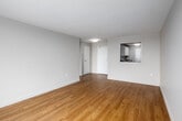 Located on the 9th floor at 10 Overlea Dr in Kitchener, Ontario, this one-bedroom, one-bathroom apartment offers a bright and efficiently designed layout. Warm hardwood-style flooring runs throughout the unit, creating a cohesive and inviting atmosphere.

The open living room is bathed in natural light, courtesy of large sliding windows that frame elevated views of the Kitchener cityscape and surrounding greenery. Baseboard heating runs beneath the windows, ensuring year-round comfort. The space flows naturally into a dedicated bedroom, which features its own large sliding window with the same expansive city views, along with a built-in double closet for ample storage.

The galley-style kitchen is neatly arranged with white cabinetry on both sides, offering generous upper and lower storage, a countertop with an undermount sink, and full-sized white appliances including a refrigerator. The clean, functional design makes efficient use of the available space.

The bathroom is finished with classic cream-toned wall tiles surrounding a full-sized soaker tub and shower combination, complemented by white fixtures for a clean, timeless look.

Throughout the unit, neutral wall tones and consistent flooring lend a bright, airy feel, making this a well-appointed urban residence with practical amenities and rewarding elevated views.