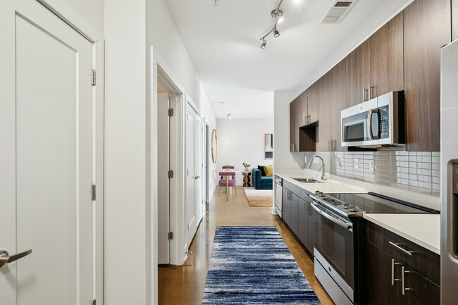 Experience the harmony of style and functionality in this contemporary kitchen layout. - Melrose Apartments