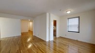 Located at 112 Hoyt St in Stamford, Connecticut, this two-bedroom, one-bathroom home offers a well-organized single-floor layout designed for comfortable everyday living. The interior is finished with warm hardwood floors throughout, lending a classic and inviting character to each room. The open living area is bathed in natural light courtesy of a prominent window fitted with blinds, creating a bright and airy atmosphere. Clean white walls complement the light wood tones of the flooring, giving the space a fresh, neutral aesthetic that is easy to personalize. A dedicated hallway connects the living area to the rest of the home, providing a clear and functional flow between rooms. The kitchen features warm wood cabinetry and is conveniently accessible from the main living space, making it practical for daily use and entertaining. The layout is thoughtfully arranged, with each area of the home transitioning naturally into the next. Overall, this residence combines timeless finishes with a practical design, making it a well-rounded home in a established Stamford neighborhood.