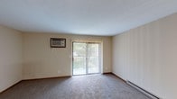 Located at 895 Ohio Pike in Cincinnati, Ohio, this single-floor unit offers a practical and comfortable layout designed for everyday living. The open living area is generously sized, featuring wall-to-wall carpeting, neutral-toned walls, a textured ceiling, and a wall-mounted air conditioning unit. A sliding glass door with vertical blinds leads to an outdoor balcony, filling the space with natural light and providing views of the surrounding greenery. A baseboard heating system runs along the perimeter, ensuring year-round comfort.

The dining area flows naturally from the living space and is accented by a classic chandelier overhead, creating a welcoming atmosphere. Adjacent to the dining area, the kitchen is equipped with warm oak cabinetry, ample counter space, a double-basin stainless steel sink, and tile-style flooring. A dishwasher is integrated into the cabinetry, adding convenience to the functional layout.

The bedroom features plush carpeting, neutral walls, a wall-mounted air conditioning unit, and a window that allows natural light to filter in, along with a closet with a wood-paneled door.

The full bathroom includes a tiled floor in a classic white grid pattern, a vanity with a wide countertop and wood cabinetry, a toilet, and a full-size bathtub with a shower surround.