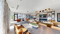 This expansive 1,130 square foot Sky Lounge, located at 10 Tower St NW in Atlanta, GA, offers a sophisticated urban retreat with breathtaking city views. The space is characterized by its open-concept design, featuring floor-to-ceiling windows that flood the area with natural light and showcase the Atlanta skyline.

The lounge is divided into multiple functional zones, each thoughtfully furnished with modern, comfortable seating. A central living area boasts plush sofas and armchairs, centered around a stylish fireplace and entertainment unit. Adjacent to this, a dining section with sleek tables and chairs provides an ideal spot for casual meetings or meals.

The kitchen area is equipped with high-end appliances and a breakfast bar, seamlessly integrating with the main space. Throughout the lounge, a neutral color palette of whites and grays is accented by warm wood tones and pops of orange in the furniture, creating a welcoming atmosphere.

A notable feature is the outdoor terrace, accessible through glass sliding doors, offering an extension of the living space with additional seating for enjoying the open air. The bathroom continues the modern aesthetic with geometric tiled walls and contemporary fixtures.

Lighting is a key element, with recessed ceiling lights, designer pendants, and an artistic chandelier contributing to the ambiance. The space is finished with curated artwork and greenery, adding personality and life to this elevated urban oasis.