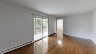 Located in Neptune, NJ, this well-appointed 2-bedroom, 1-bathroom residence offers a practical and comfortable single-floor layout. Rich hardwood flooring flows throughout the living spaces, lending warmth and continuity to the home.

The kitchen is a functional standout, featuring rich dark wood cabinetry, a classic subway tile backsplash, and a full suite of stainless steel appliances including a gas range, built-in microwave, dishwasher, and refrigerator. Light-toned flooring complements the cabinetry for a clean, balanced aesthetic.

The living room is bright and inviting, with gleaming hardwood floors and sliding glass doors that open onto a private balcony overlooking lush greenery — an ideal space for relaxing or entertaining.

The primary bedroom is generously sized and includes a sliding-door closet with built-in hanging storage, along with dark hardwood flooring. The second bedroom offers hardwood floors, a window with natural light, and a wall-mounted air conditioning unit. Both bedrooms are finished with neutral tones throughout.

The bathroom features a full tub-shower combination surrounded by crisp white textured tile, giving it a clean, modern feel.

A connecting hallway ties all rooms together efficiently, completing this well-organized and move-in-ready Neptune residence.