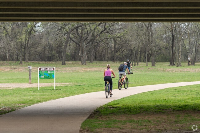 Burleson Residents biking through Bailey Lake Park.