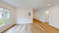 Located at 399 Erbes Rd in Thousand Oaks, CA, this thoughtfully updated 2-bedroom, 1-bathroom single-floor unit offers a clean, modern aesthetic throughout. Light-toned wood flooring flows seamlessly across every room, creating a bright and cohesive feel. The open living and dining area is generously proportioned, with recessed lighting, a wall-mounted mini-split unit for climate control, and direct access to an outdoor area via a paneled entry door flanked by a window. The kitchen is well-appointed with white shaker cabinetry, quartz countertops, stainless steel appliances including a dishwasher, range, and microwave, and a window above the sink that brings in natural light. Both bedrooms are comfortable and bright, each featuring a ceiling fan with light fixture and windows with blinds. The primary bedroom includes a mirrored sliding closet door, adding depth and functionality. A second closet provides additional storage. The bathroom is finished in a crisp black-and-white palette with white subway tile in the tub/shower surround, a quartz-topped vanity with shaker cabinets, matte black fixtures and hardware, and wood-look flooring. A hallway connects the main living areas to the bedrooms and bathroom, completing this well-organized and move-in-ready layout.