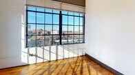 This contemporary condo offers 870 square feet of thoughtfully designed living space. The open-concept layout seamlessly connects the kitchen, living, and dining areas, creating an ideal flow for modern living. Large windows flood the space with natural light and provide stunning city views. The kitchen boasts granite countertops and stainless steel appliances, perfect for culinary enthusiasts. Both bedrooms are generously sized, with the primary bedroom spanning 170 square feet. Hardwood floors throughout add warmth and character, while exposed ductwork lends an industrial chic aesthetic. The two full bathrooms feature modern fixtures and finishes. This unit combines urban sophistication with practical amenities for comfortable city living.