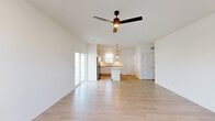 Located at 615 Starling Circle in Oswego, IL, this two-story home offers three bedrooms and three bathrooms across two well-proportioned floors. The main level is anchored by an open-concept living and kitchen area finished with light hardwood-style flooring throughout. The kitchen is equipped with white shaker cabinetry, granite countertops, stainless steel appliances, a central island with pendant lighting, and a window above the sink that brings in natural light. The living room is bright and airy, featuring a ceiling fan, large sliding glass door, and multiple windows that fill the space with daylight. A staircase with a white balustrade connects the main floor to the upper level. Upstairs, the generously sized primary bedroom features dual windows, a ceiling fan, hardwood-style flooring, and direct access to an en-suite bathroom and a walk-in closet with wire shelving. Additional bedrooms are carpeted and include ceiling fans and windows with outdoor views. The bathrooms are finished with granite vanity tops and chrome fixtures, with at least one full walk-in shower with a sliding glass door. Two closets provide ample storage throughout the home. Clean white walls and consistent finishes give the entire space a modern, move-in-ready feel.