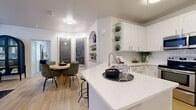 Located at 1131 Courtney Trace Drive in Brandon, FL, this single-story 2-bedroom, 2-bathroom home offers a thoughtfully designed open-concept layout with modern finishes throughout. Light wood-style flooring flows through the main living areas, creating a cohesive and airy feel.

The kitchen is a standout feature, showcasing crisp white shaker cabinetry, quartz countertops, a classic subway tile backsplash, stainless steel appliances, and a peninsula with bar seating — ideal for casual dining or entertaining. An arched built-in niche adds architectural character between the kitchen and dining area. The dining space is framed by a corner window arrangement and a decorative built-in shelf niche, adding depth and charm.

The living room benefits from natural light through sliding glass doors and features a ceiling fan for year-round comfort. Both bedrooms are carpeted for warmth and comfort. The primary bedroom is generously proportioned with ample closet space. The bathrooms are finished in white cabinetry with clean, modern fixtures.

A dedicated in-unit laundry room with full-size washer and dryer hookups adds everyday convenience. With two closets and a hallway connecting the private spaces, this home balances functionality with refined, contemporary style.